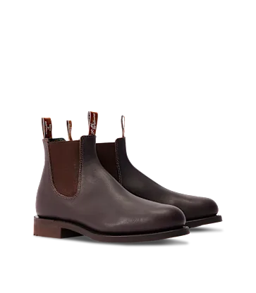Pair of brown leather Chelsea boots on a white background