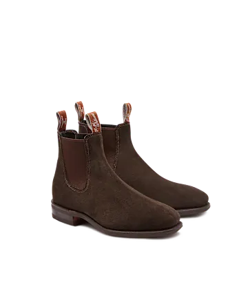 Pair of brown suede Chelsea boots on a white background