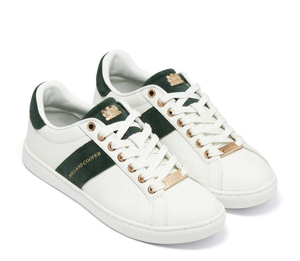 White sneakers with green accents and gold branding on a white background