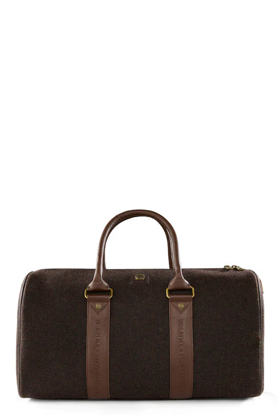 Brown travel bag with leather straps on a white background