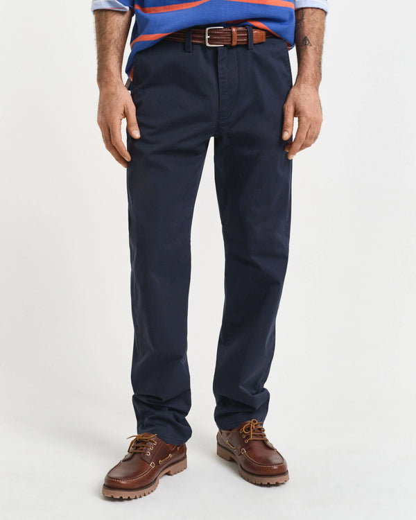 Navy pants worn by a person on a white background