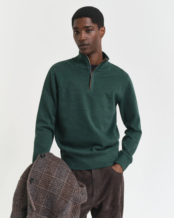 Man wearing a green sweater with a white background