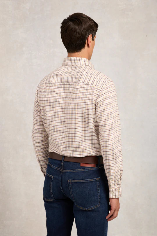 Man wearing a plaid shirt and jeans from behind on a plain background
