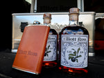Two bottles of Jim Beam and a brown flask with a blurred background