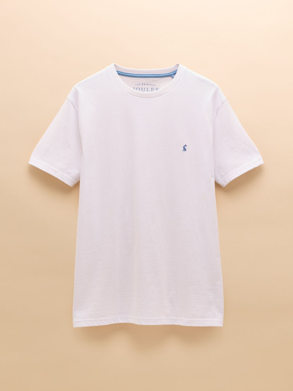 White t-shirt with a small logo on a beige background