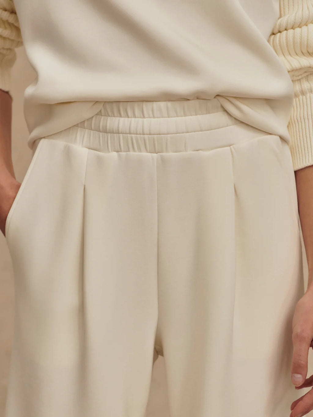 Beige pants worn by a person, with a focus on the garment.