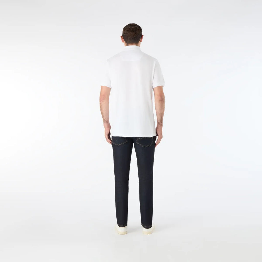 Person wearing a white t-shirt and dark jeans on a white background