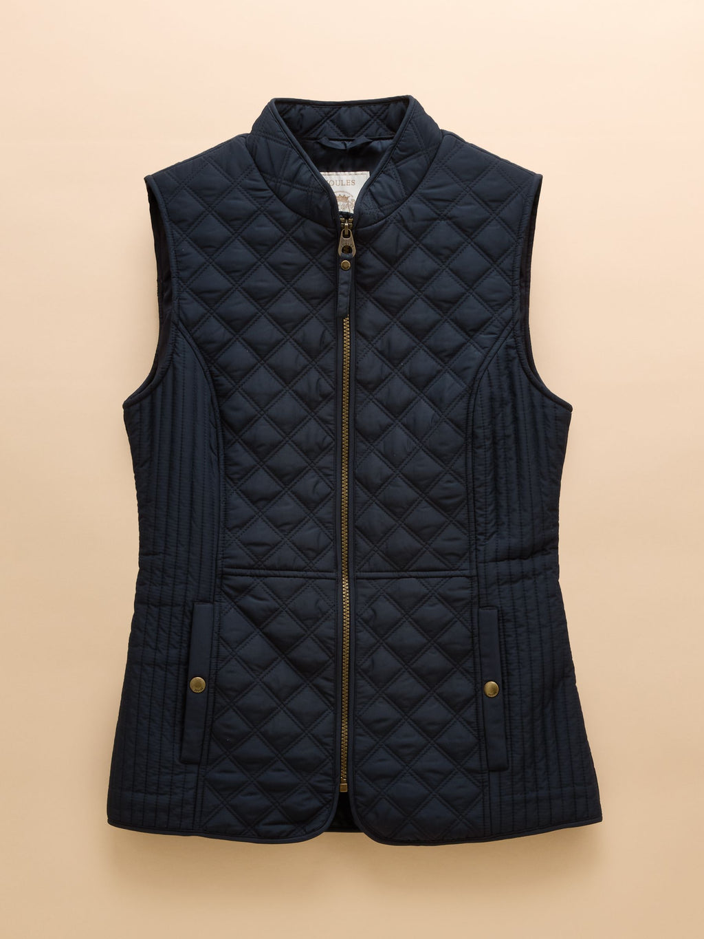 Navy quilted vest on a beige background
