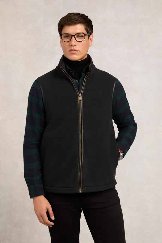 Man wearing a black and green checkered fleece jacket on a plain background