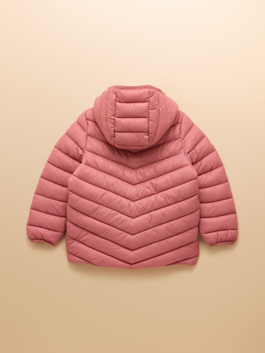 Pink quilted jacket on a beige background