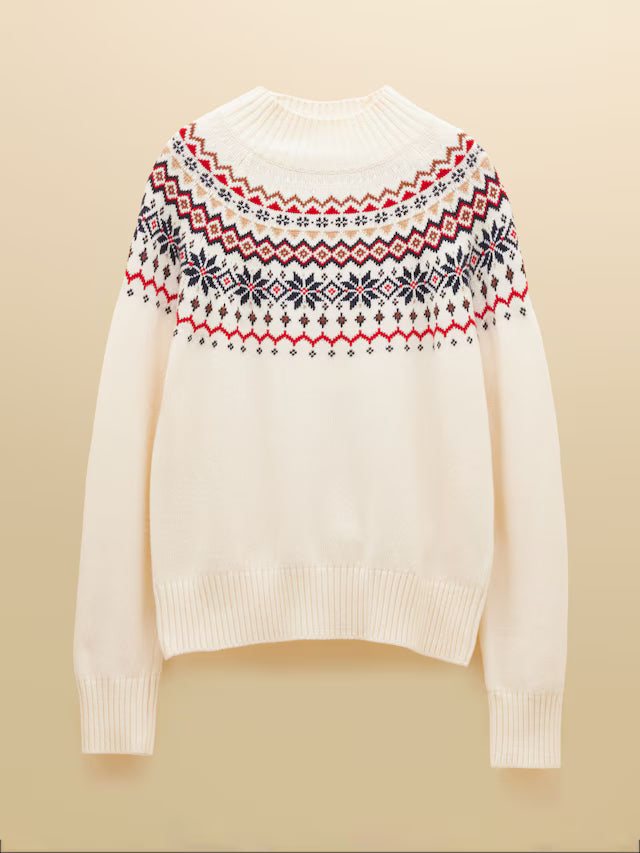 White sweater with a colorful pattern on the back against a beige background