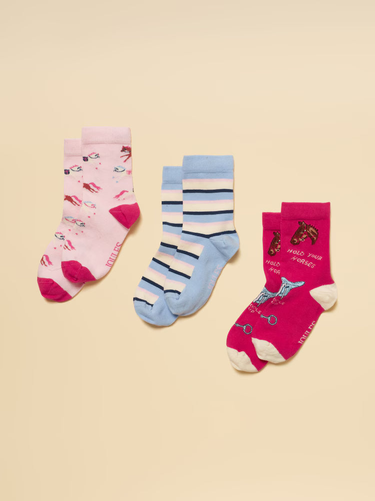 Three pairs of colorful socks on a beige background