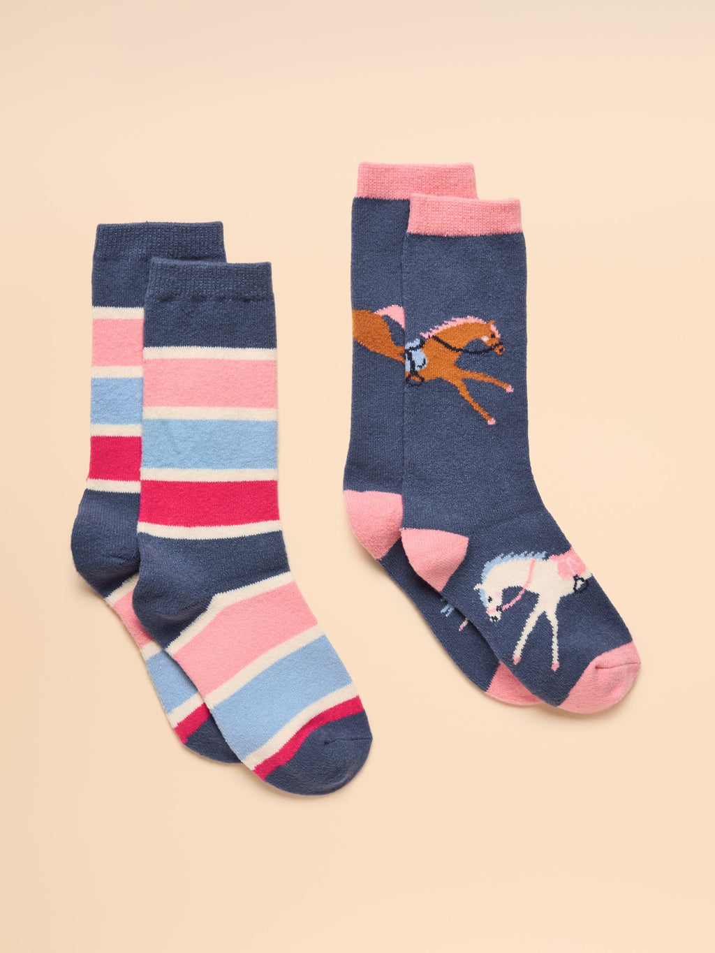 Two pairs of socks with horse designs on a beige background