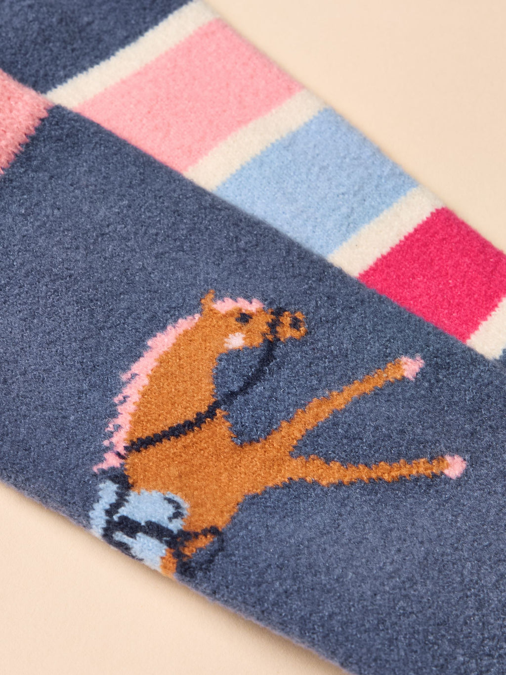 Textured sock with a horse design on a checkered background
