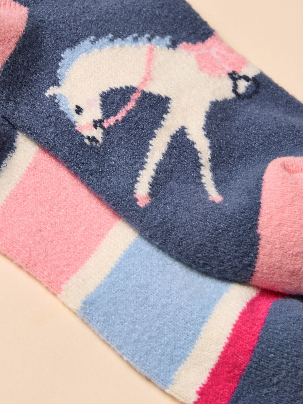Fuzzy blanket with a unicorn design on a pink background