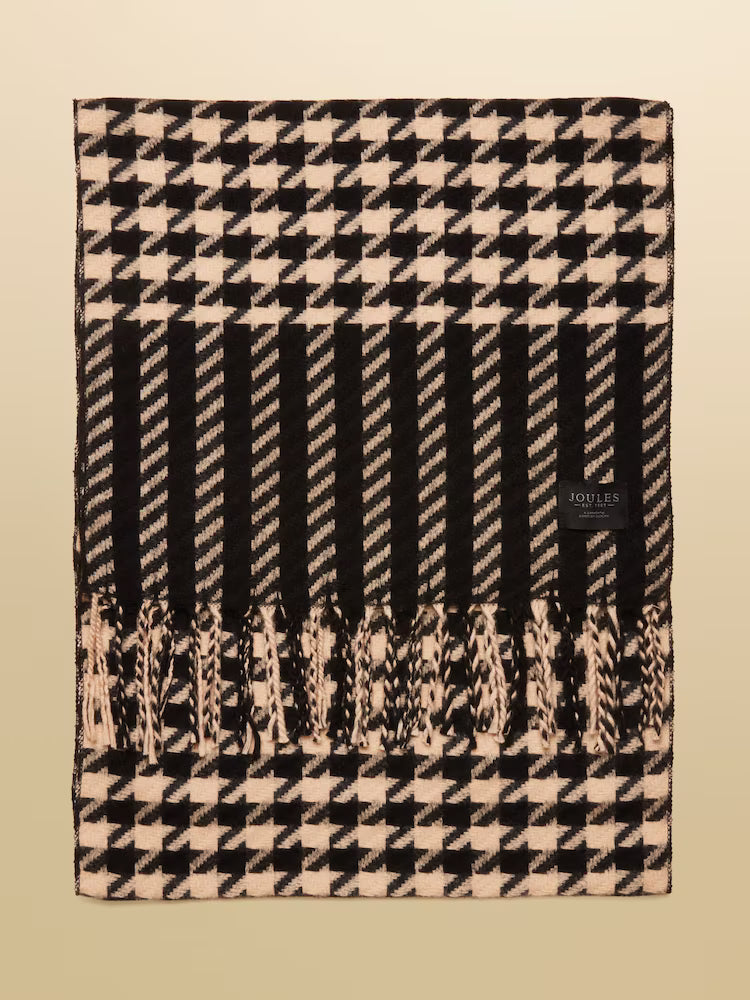 Black and beige checkered blanket with a brand label on a beige background