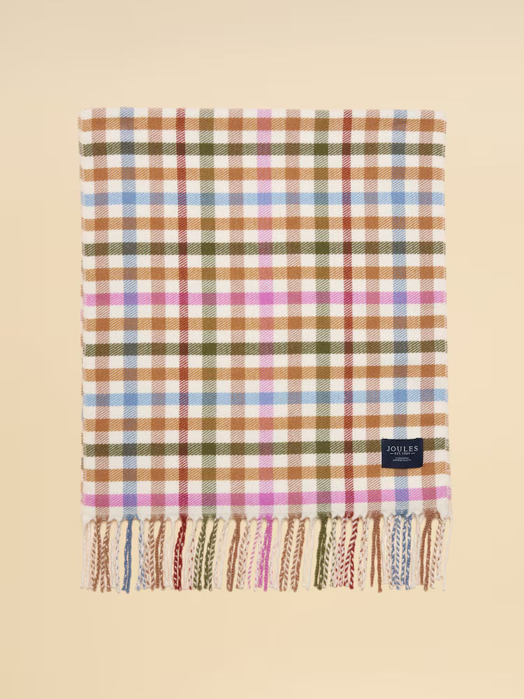 Plaid blanket with fringes on a beige background