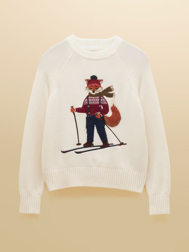 White sweater with a red panda skiing design on a beige background
