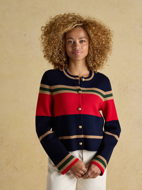 Woman wearing a striped sweater with a beige background