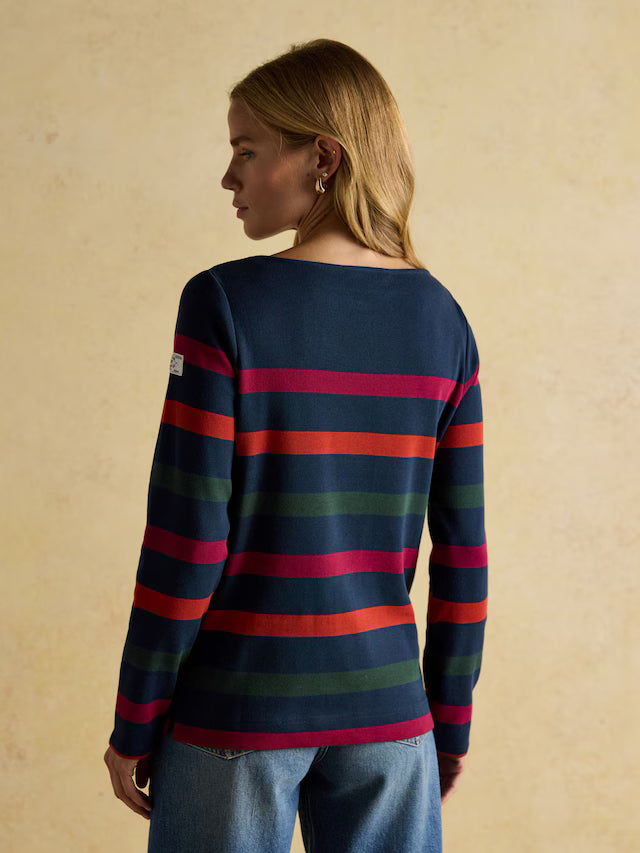 Woman wearing a striped sweater with a beige background