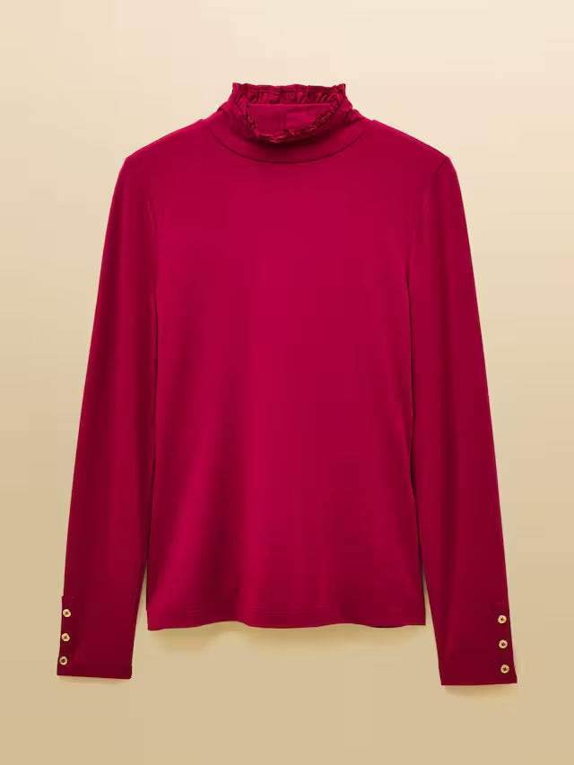 Red turtleneck sweater with gold buttons on a beige background