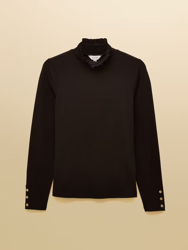 Black long-sleeve top with ruffled collar on a beige background