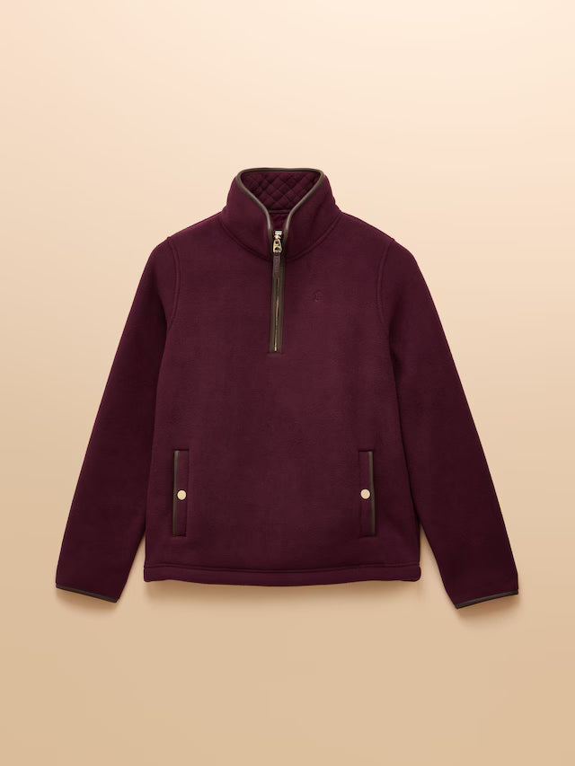 Maroon fleece pullover with a zipper on a beige background