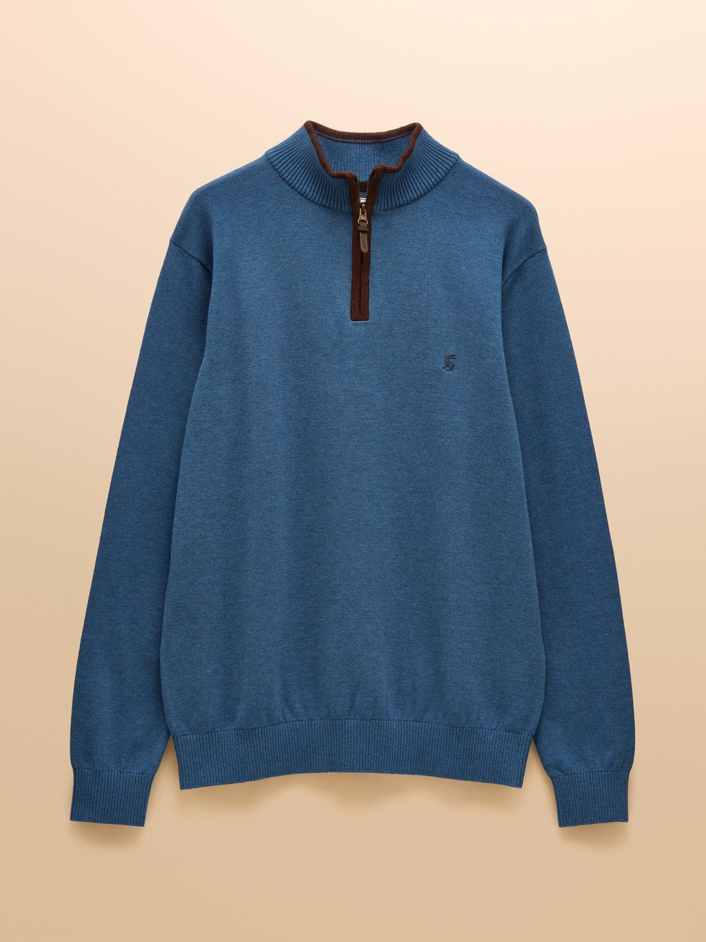Blue sweater with a zipper on a beige background