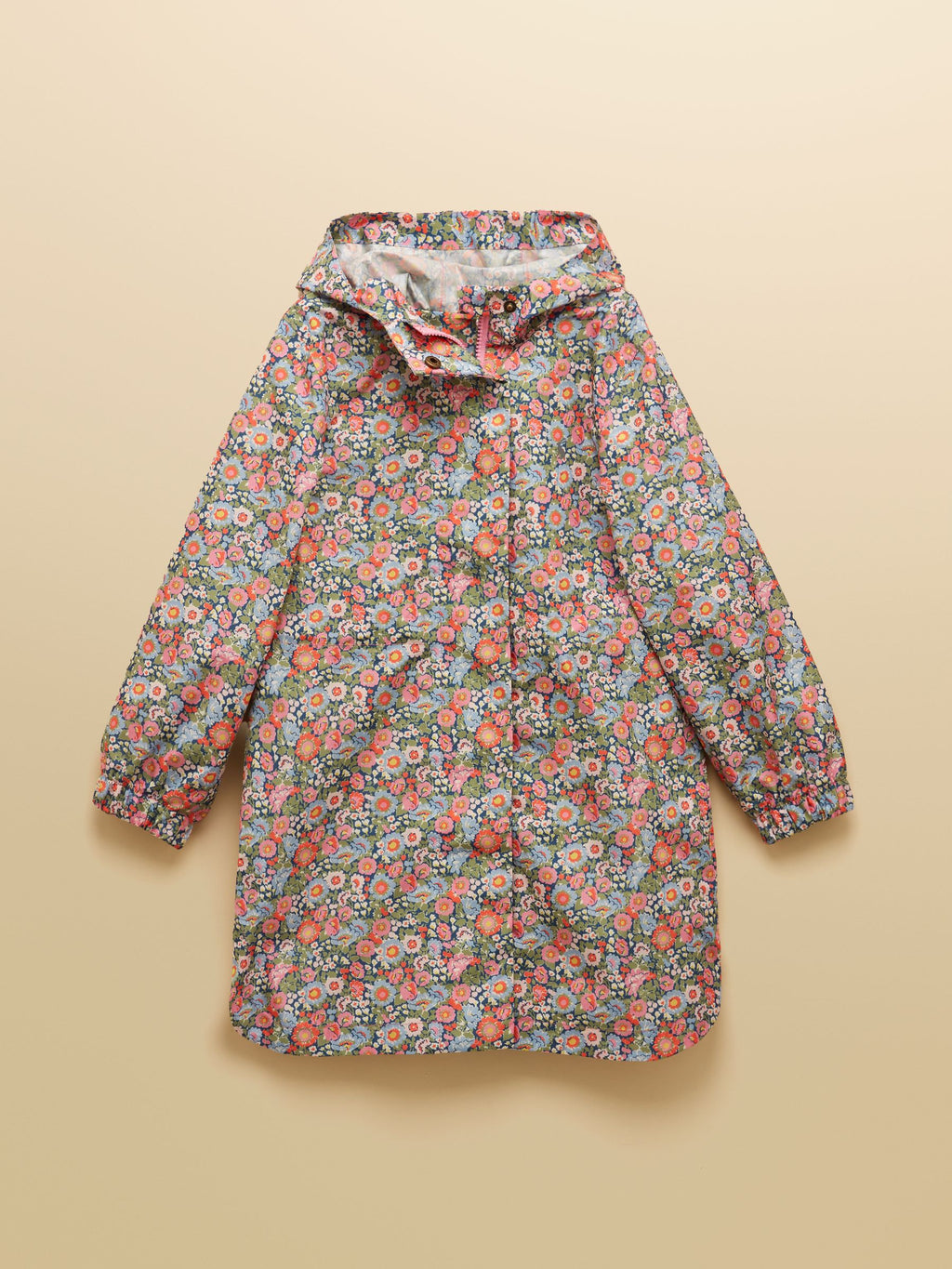 Floral-patterned raincoat on a beige background