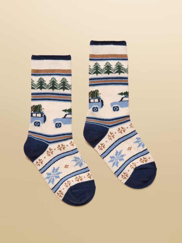 Pair of socks with winter-themed design on a beige background