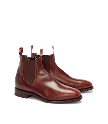 Pair of brown leather Chelsea boots on a white background