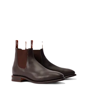 Pair of brown leather Chelsea boots on a white background