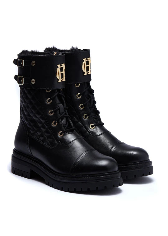 Black leather boots with gold buckles and logo on a white background