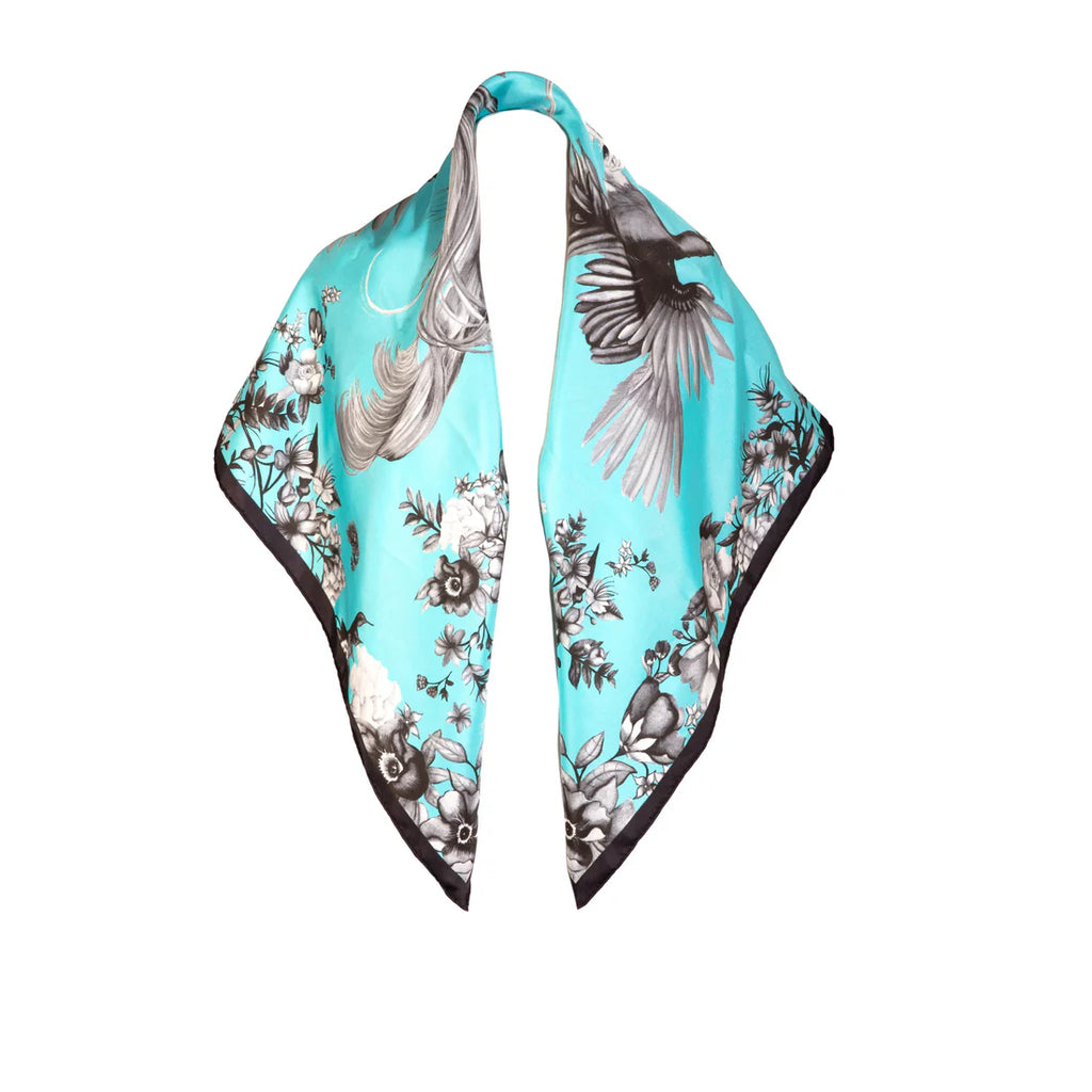 Teal scarf with bird and floral pattern on a white background