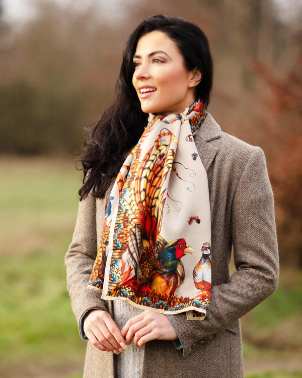 Woman wearing a colorful scarf with nature-themed design outdoors