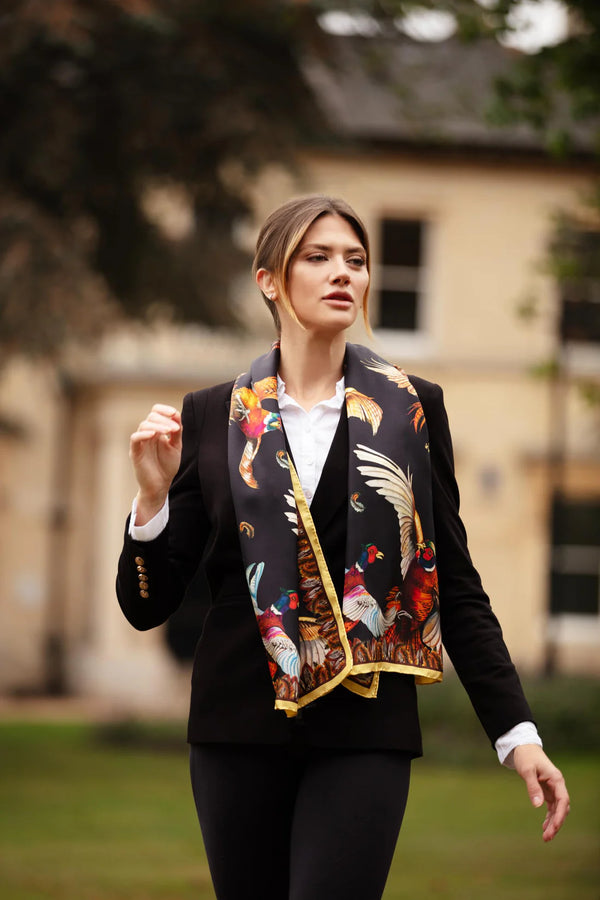 Woman wearing a patterned scarf outdoors with a blurred background