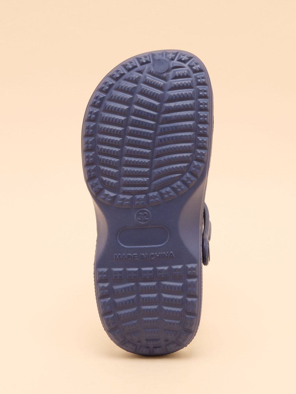 Navy blue shoe sole on a beige background