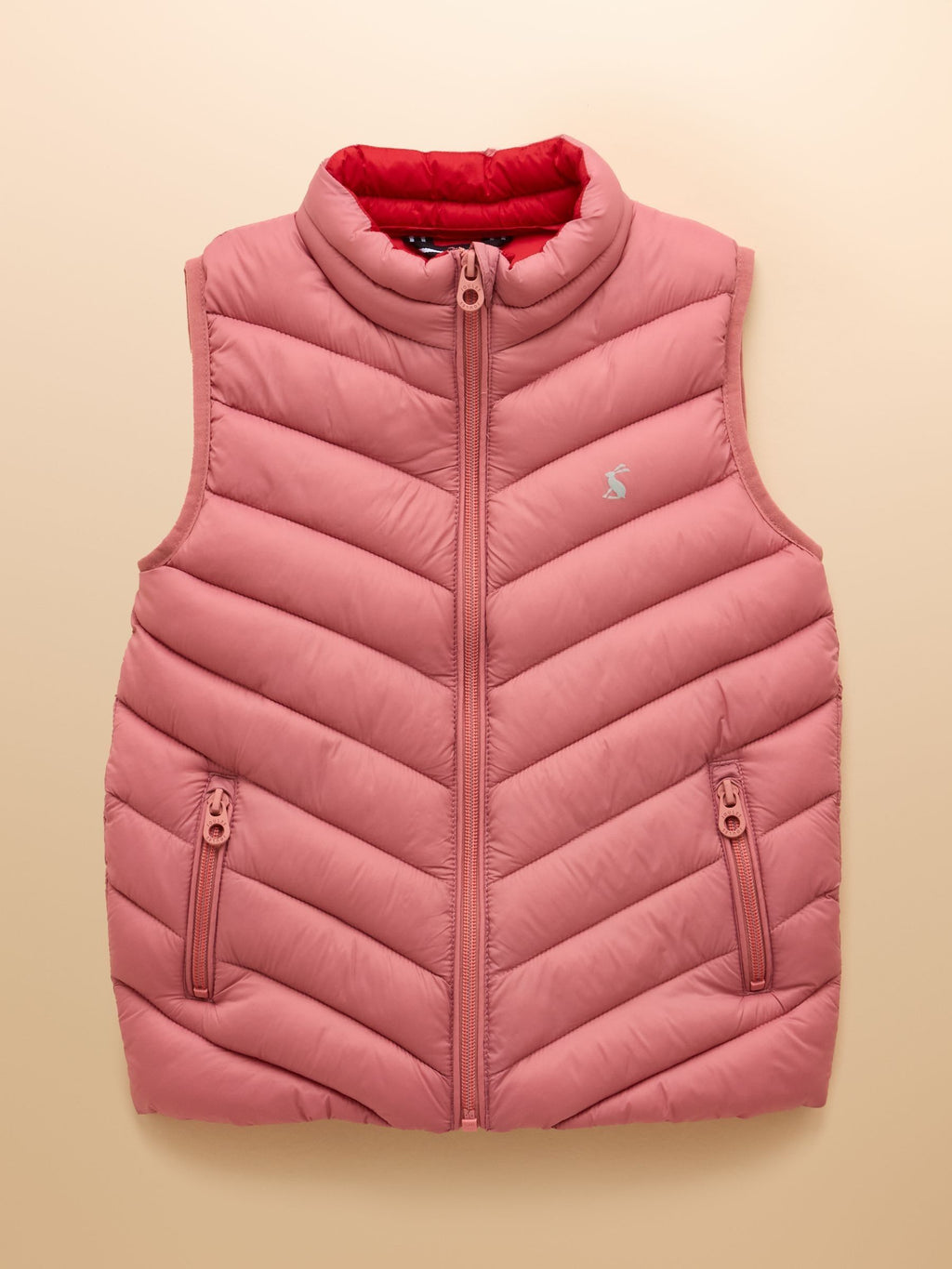 Pink puffer vest with a brand logo on a beige background