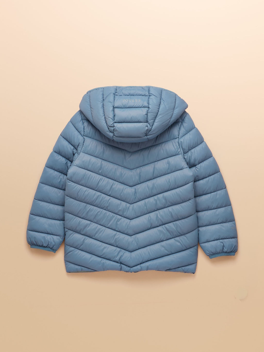 Blue puffer jacket with a hood on a beige background