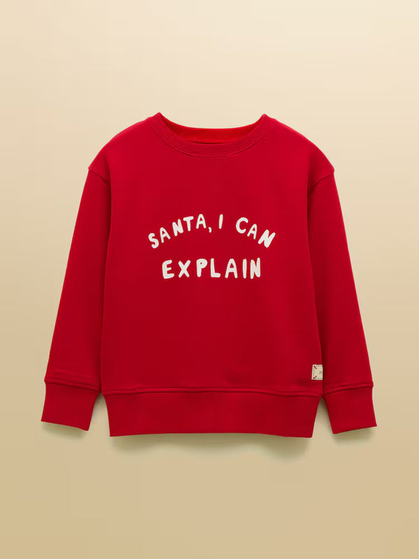 Red sweatshirt with 'Santa, I can explain' text on a beige background