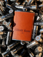 Brown flask with 'Elliott Ross' branding on a background of bullets