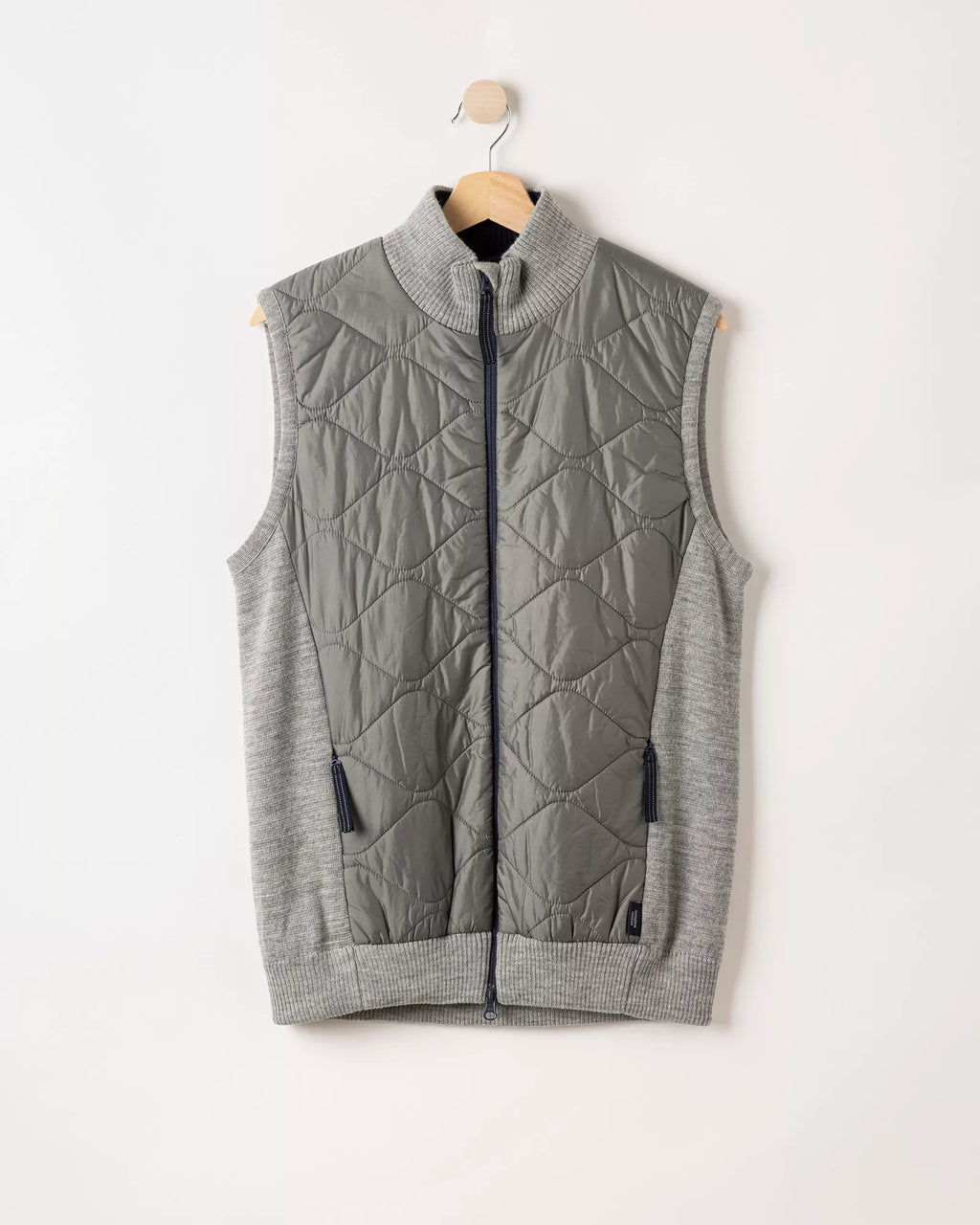 Gray quilted vest on a hanger against a white background