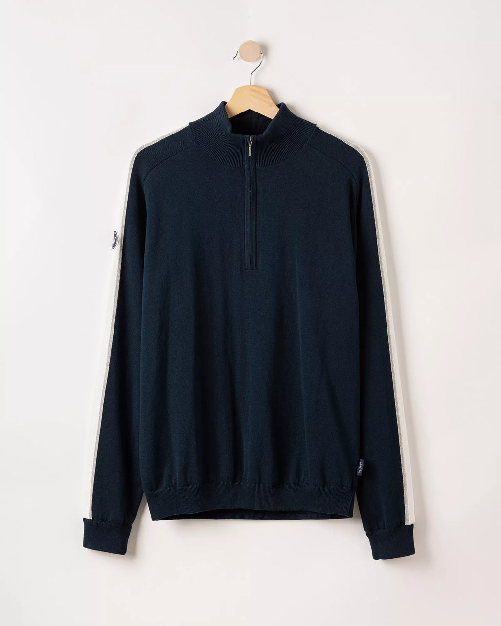 Navy blue half-zip sweatshirt on a hanger against a white background