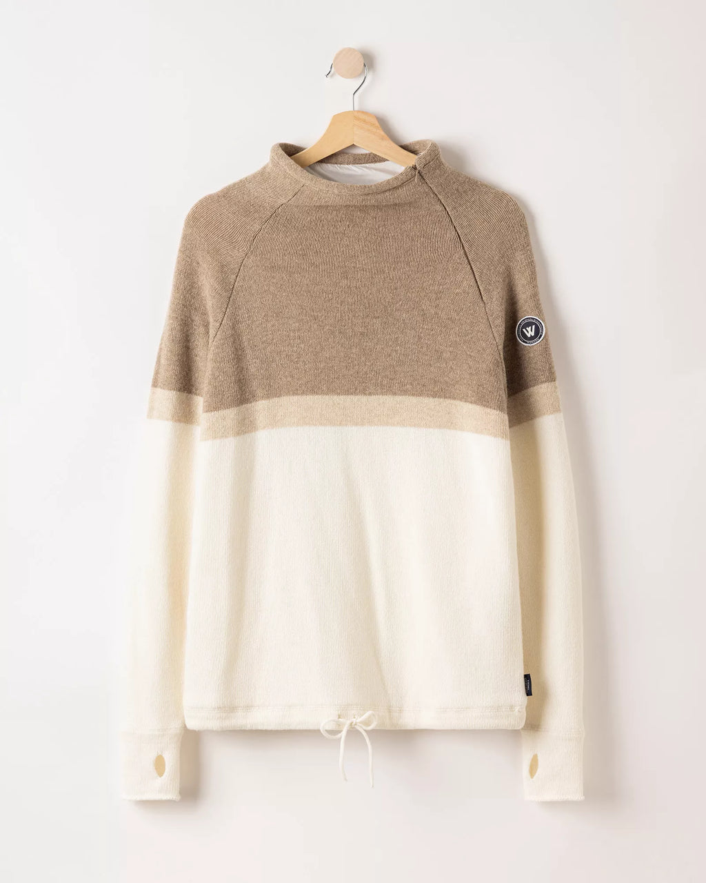 Two-tone brown and beige sweater on a hanger against a white background