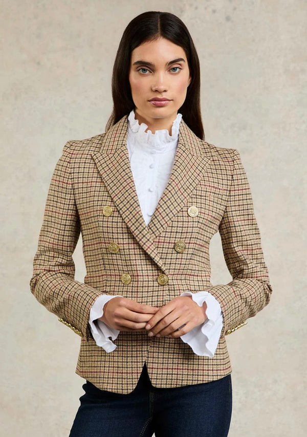 Woman wearing a checkered blazer over a white shirt with a neutral background