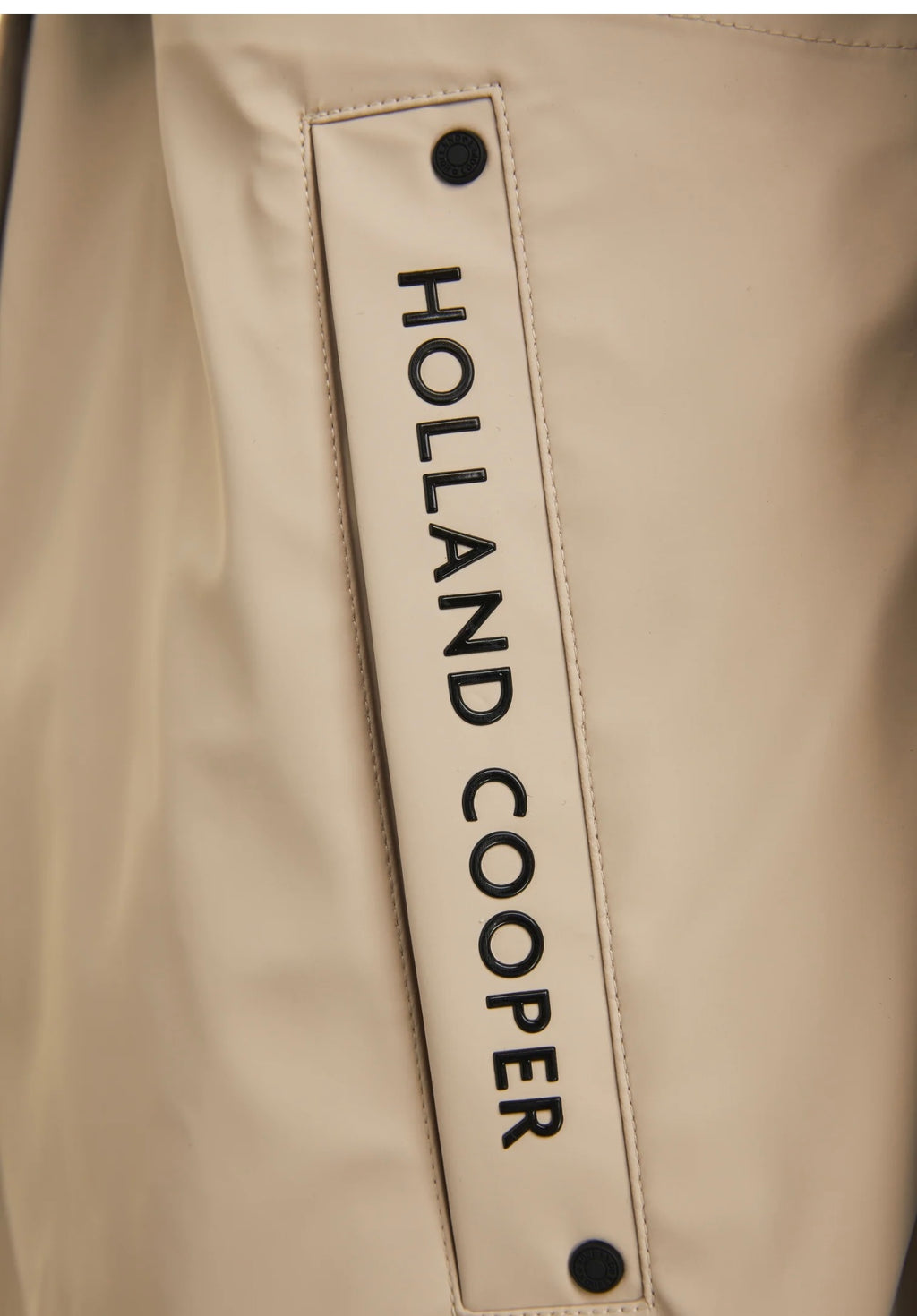 Beige jacket with 'Holland Cooper' branding on a beige background