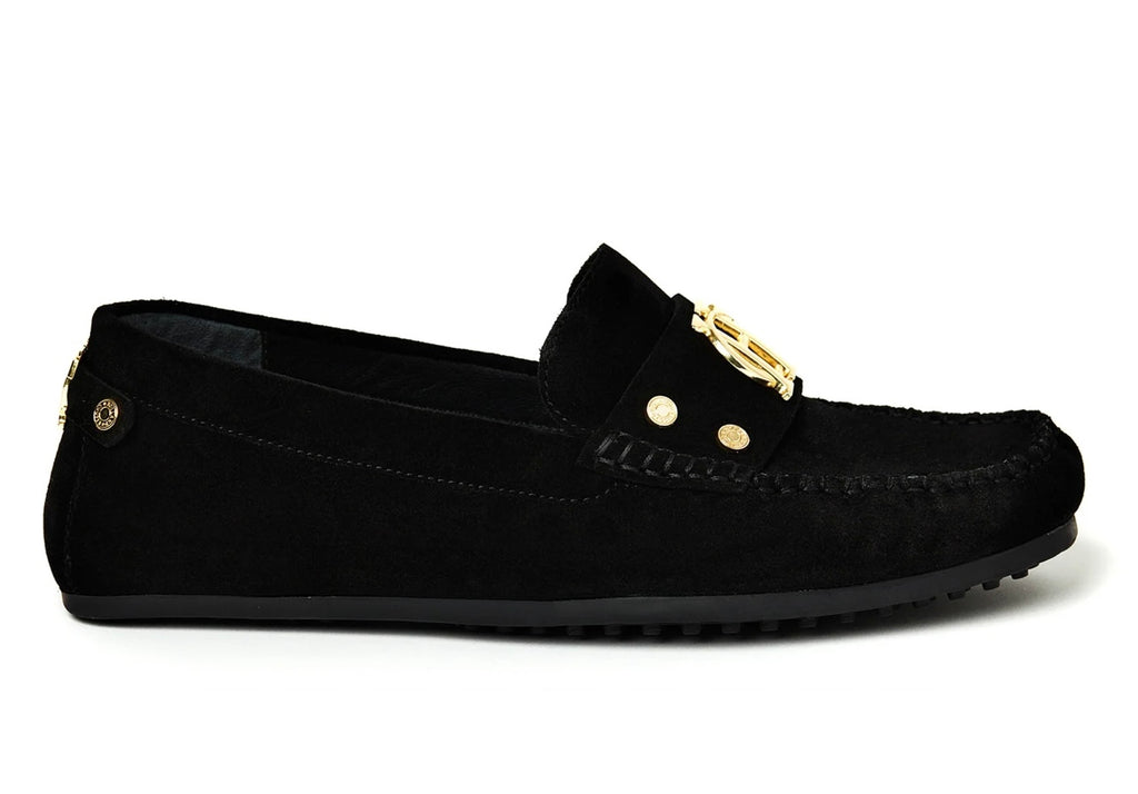 Black suede loafer with gold accents on a white background