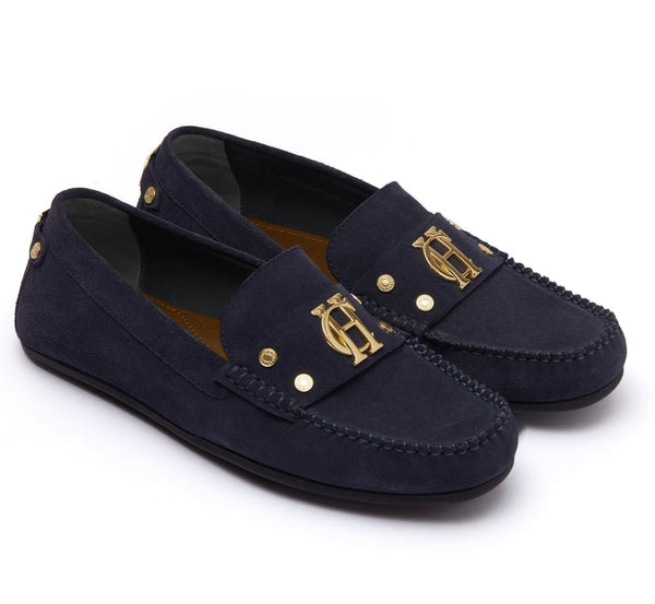 Navy loafers with gold accents on a white background