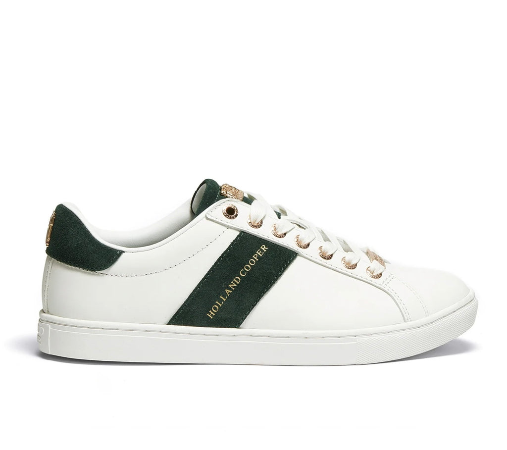 White sneaker with black accents and 'Holland Cooper' branding on a white background