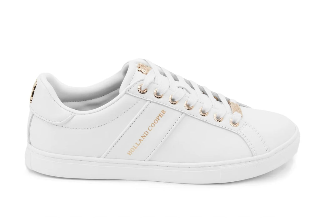 White sneaker with gold accents on a white background